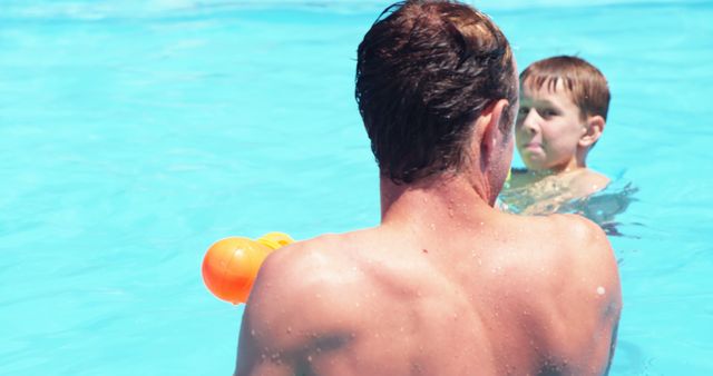 Father and Son Playing with Water Toy in Swimming Pool - Download Free Stock Images Pikwizard.com