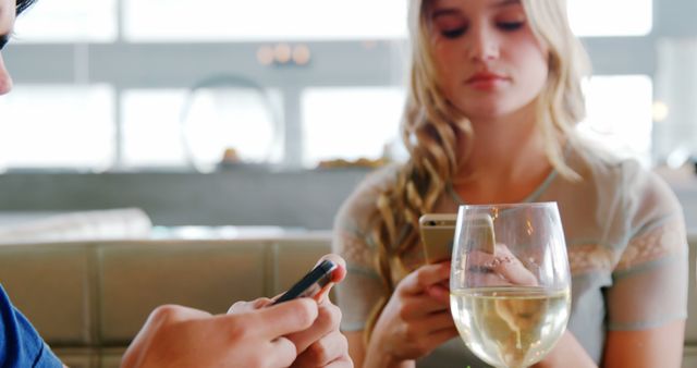 Young Adults Texting on Smartphones at Restaurant Table - Download Free Stock Images Pikwizard.com