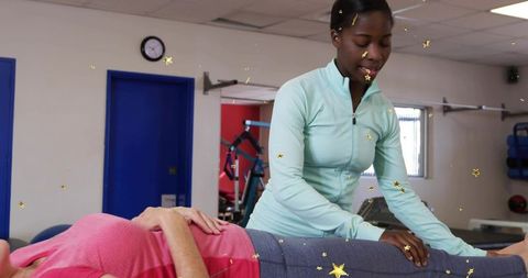 Therapist assessing patient on treatment table during rehab and manual therapy session for recovery