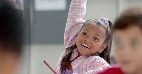 Young biracial girl engaged in classroom discussion