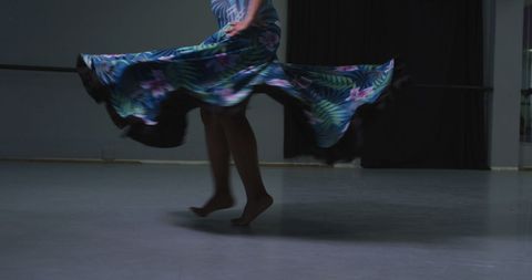 Elegant dance movement in colorful long dress at studio