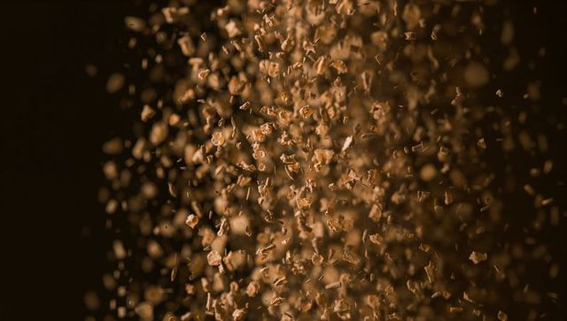 Swirling wood shavings in air with warm lighting