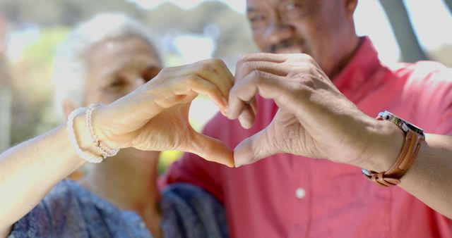 Senior Couple Making Heart Shape With Hands Outdoors - Download Free Stock Images Pikwizard.com