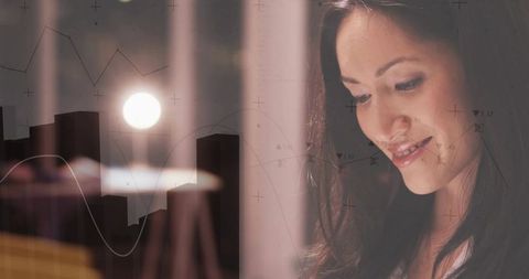 Gazing woman studying data with warm lamp glow, chart overlays and soft bokeh