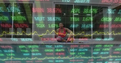 African American Woman Practices Yoga Amidst Stock Market Graphics