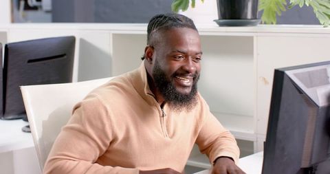 Portrait of African American Man Focused on Computer in Office Environment