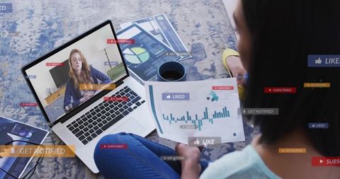Remote analyst reviewing charts on laptop while watching video call with notification alerts