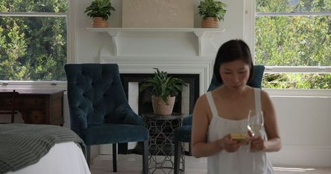 Woman Relaxing Indoors with Wine in Tranquil Home Setting