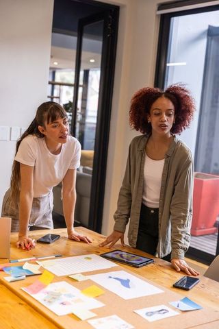 Diverse Female Coworkers Brainstorming Design Ideas in Office