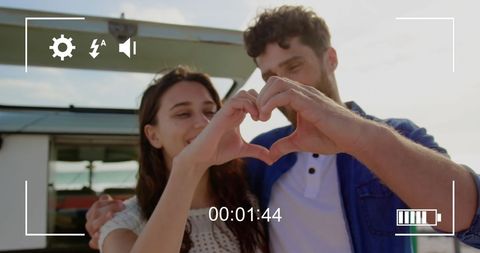 young couple making heart with hands captured in nostalgic moment - Download Free Stock Images Pikwizard.com