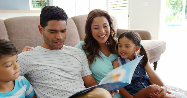 Smiling Family Reading Book Together in Living Room - Download Free Stock Images Pikwizard.com