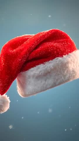 Rotating Santa Hat with Falling Snowflakes on Soft Blue Backdrop Vertical Holiday Video
