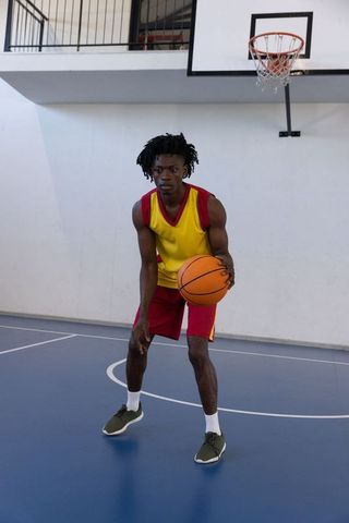 Basketball Player Dribbling on Open Court Ready for Action