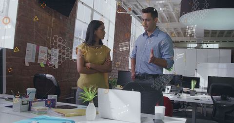 Coworkers Analyzing Data Visualizations in Modern Office Space