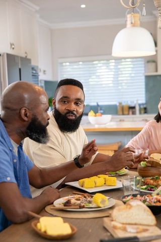 Family Sharing Meal Around Rustic Kitchen Table