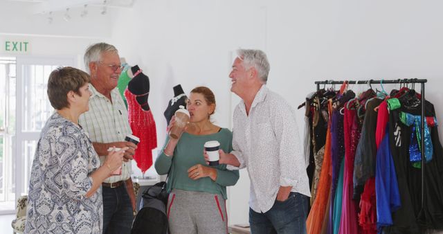 Group Friends Enjoying Coffee Together in Clothing Boutique - Download Free Stock Images Pikwizard.com