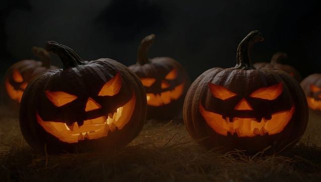 Glowing Halloween Jack-O'-Lanterns Spreading Eerie Illumination in Hayfield