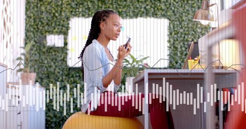 Businesswoman Analyzing Data While Talking on Smartphone