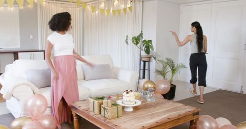 Friends Preparing Baby Shower in Cheerful Living Room Scene