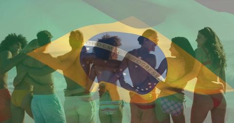 Friends linking arms on beach celebrating summer with brazilian flag overlay at golden hour