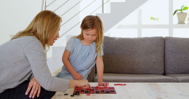 Mother and Daughter Playing Checkers in Bright Modern Living Room - Download Free Stock Images Pikwizard.com