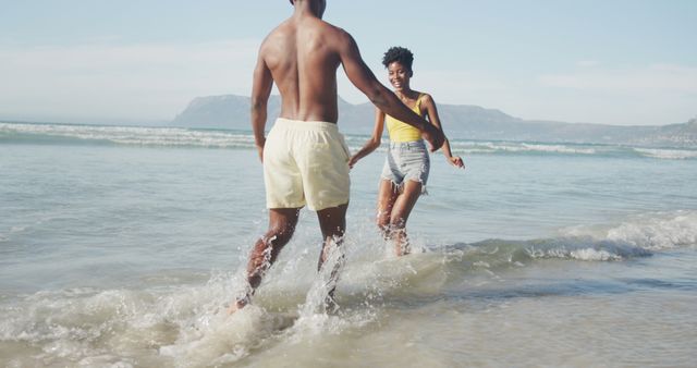 Young Black Couple Playing in Ocean Waves at Beach - Download Free Stock Images Pikwizard.com