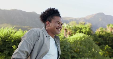 Joyful Man Relishing Nature with Mountains and Greenery