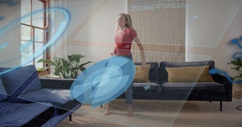 Woman wearing red t-shirt using augmented reality overlays in modern sunlit living room