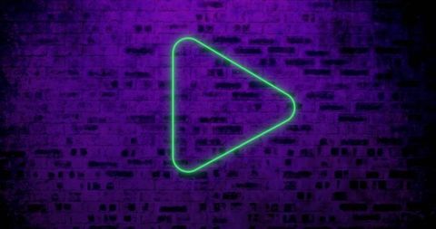 Neon green play button on purple brick wall