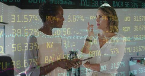 Businesswomen Discussing Data with Stock Ticker Overlay
