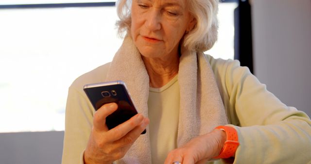 Senior Woman Checking Her Smartphone and Smartwatch - Download Free Stock Images Pikwizard.com