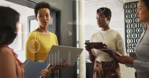 Business Team Analyzing Financial Data with Futuristic Graphics Overlay