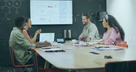 Four Professionals Analyzing Data in Modern Office