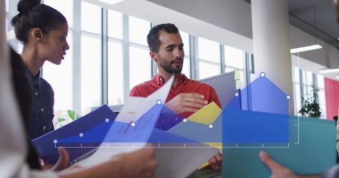 Presenting data-driven strategy with blue graph overlay in bright collaborative office