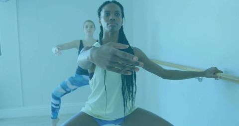 Women Exercising at Ballet Barre in Studio for Fitness and Balance