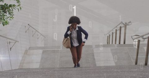 this image portrays an african american businesswoman climbing stairs while engaged in conversation on her smartphone. the overlay of numbers suggests a theme of technology and data, emphasizing a modern, dynamic business environment. suitable for concepts like business communication, ambition, advancement, and incorporating technology in everyday life, this visualization can be used in marketing materials, business presentations, and articles on professional success.