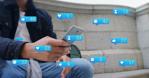 Young man holding smartphone on urban steps with social media likes comments overlays
