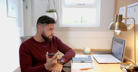 Focused business professional analyzing market data in home office