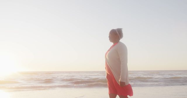 Senior Woman Enjoying Sunset Walk at Beach - Download Free Stock Images Pikwizard.com