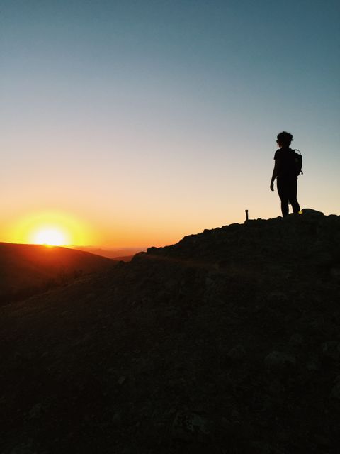 Silhouette of Hiker on Hilltop During Sunset - Download Free Stock Photos Pikwizard.com
