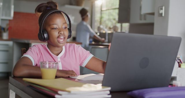 African american girl learning online using laptop at home. Lifestyle, childhood, communication, online education and domestic life, unaltered.