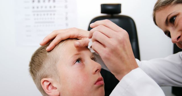 Ophthalmologist Administering Eye Drops to Young Boy in Clinic - Download Free Stock Images Pikwizard.com