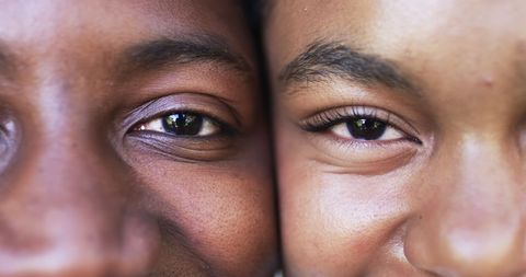 Close-up of eyes of a diverse couple sharing intimate moment