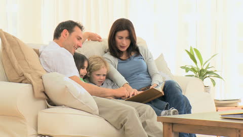 Happy Family Enjoying Photo Album at Home