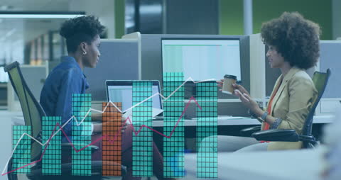 Diverse Entrepreneurs Analyzing Financial Growth Data in Modern Office