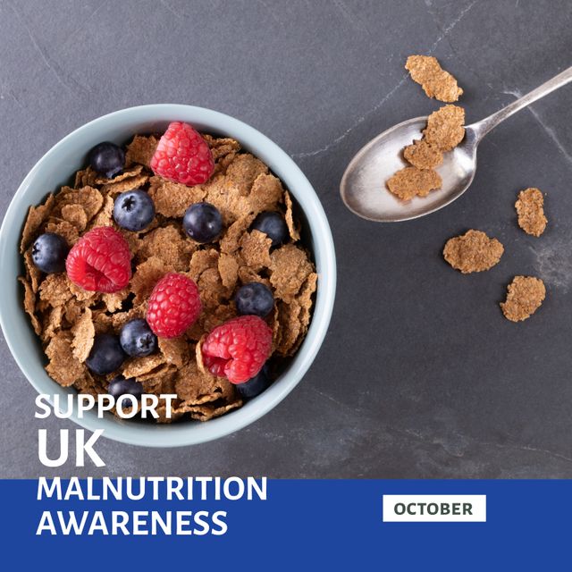 Image showing a bowl of flake cereal with fresh raspberries and blueberries, paired with text promoting UK malnutrition awareness in October. Useful for health campaigns, blog posts about nutritional education, social media shares for awareness month initiatives, and educational materials highlighting the importance of a balanced diet.
