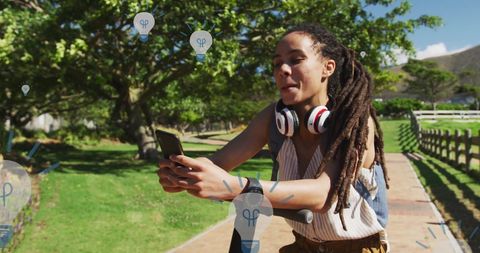 Woman engaging with digital media and light bulb digital concepts