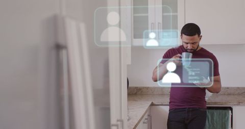 Man interacting with social media on smartphone in modern kitchen