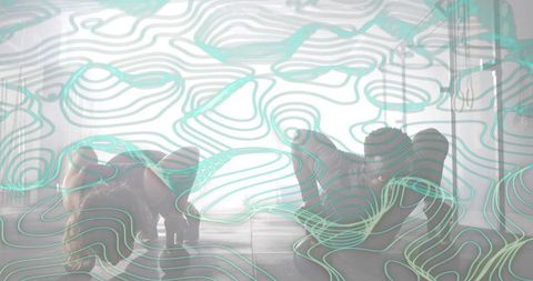 Backlit duo performing floorwork in studio with teal topographic contour overlay