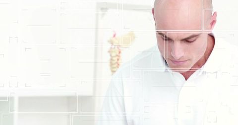 Bald man focusing in bright medical clinic with spine chart and minimalist interior